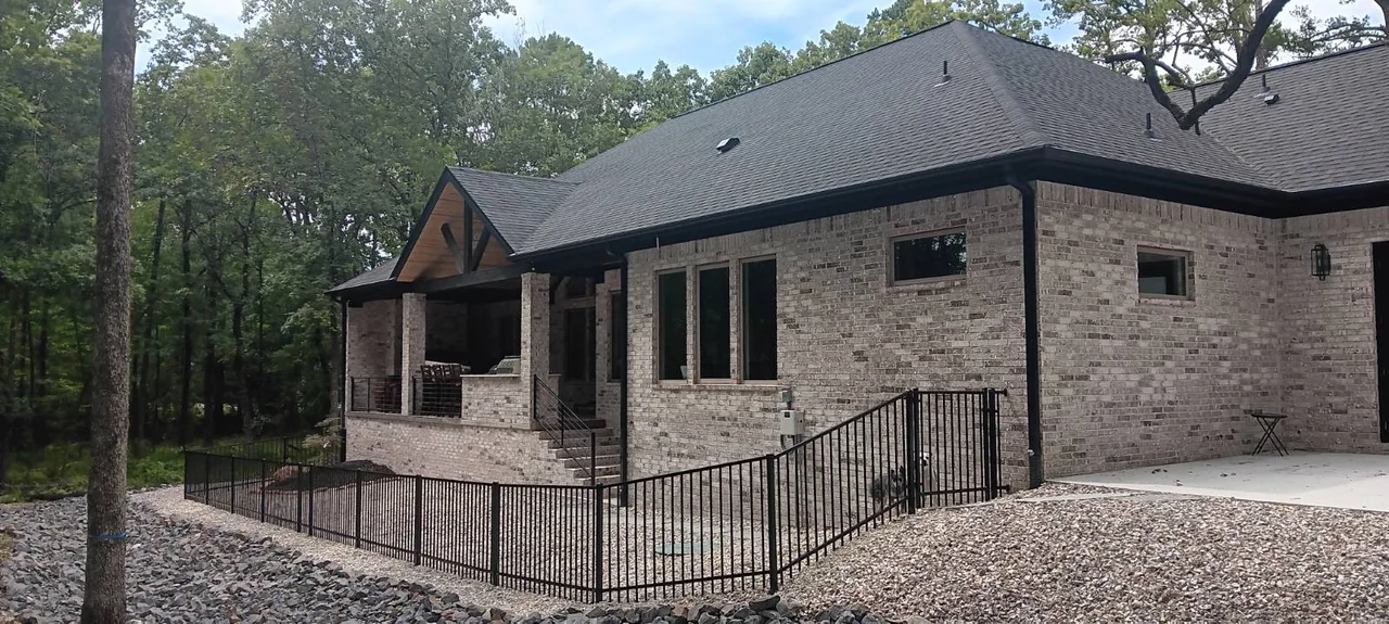 Black metal railing on a brick home